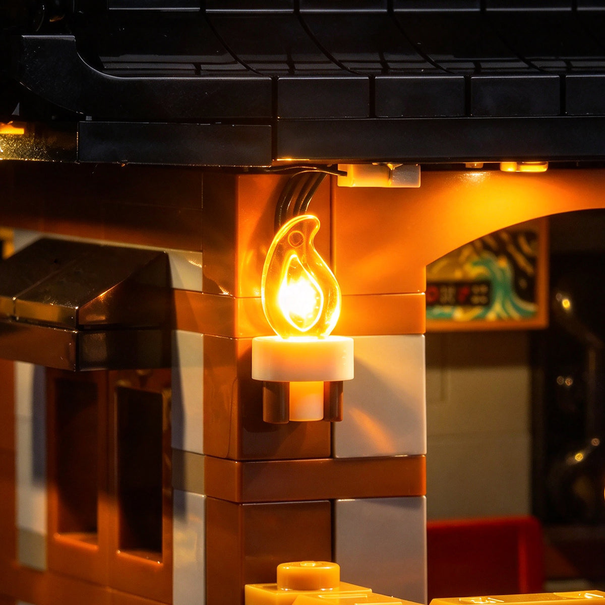 BrickBling flame LED light glowing inside a LEGO castle wall