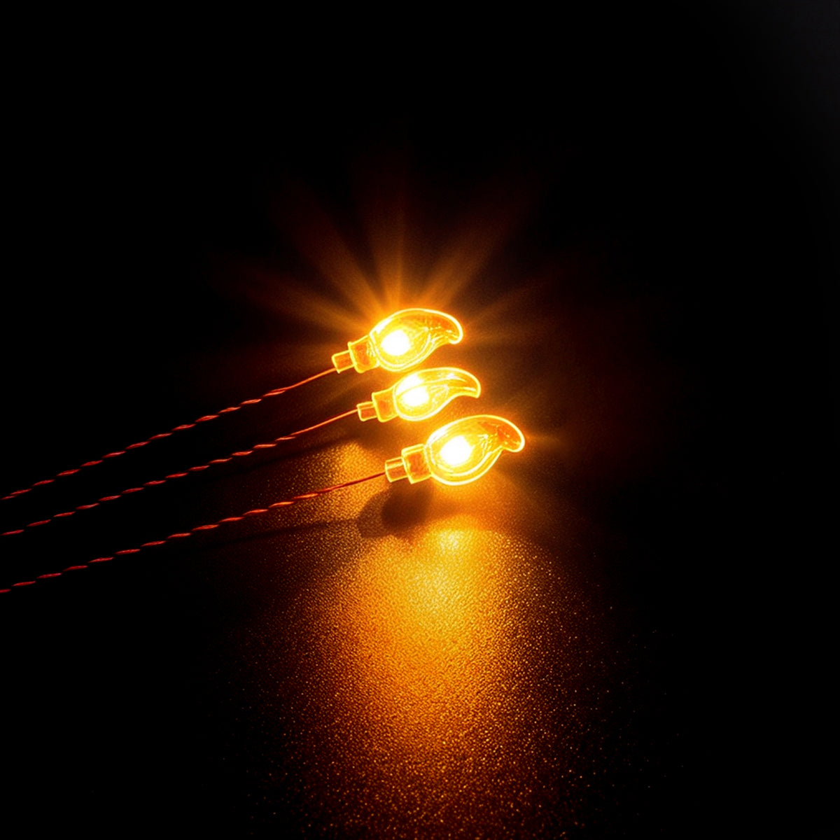 Close-up of some BrickBling DIY flame LED light accessory with a warm amber glow