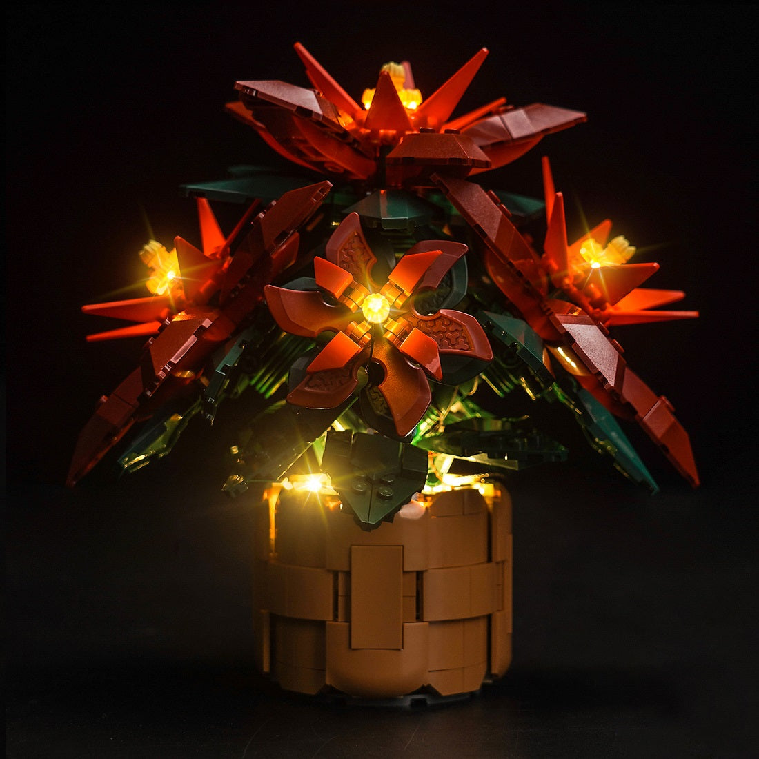 LEGO Icons Poinsettia 10370 illuminated with BrickBling LED lights against a black background